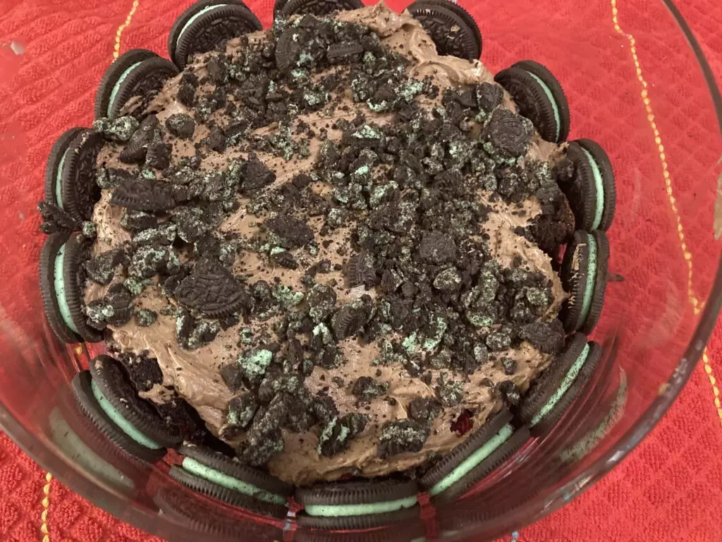 laying the trifle with crushed mint Oreos on top