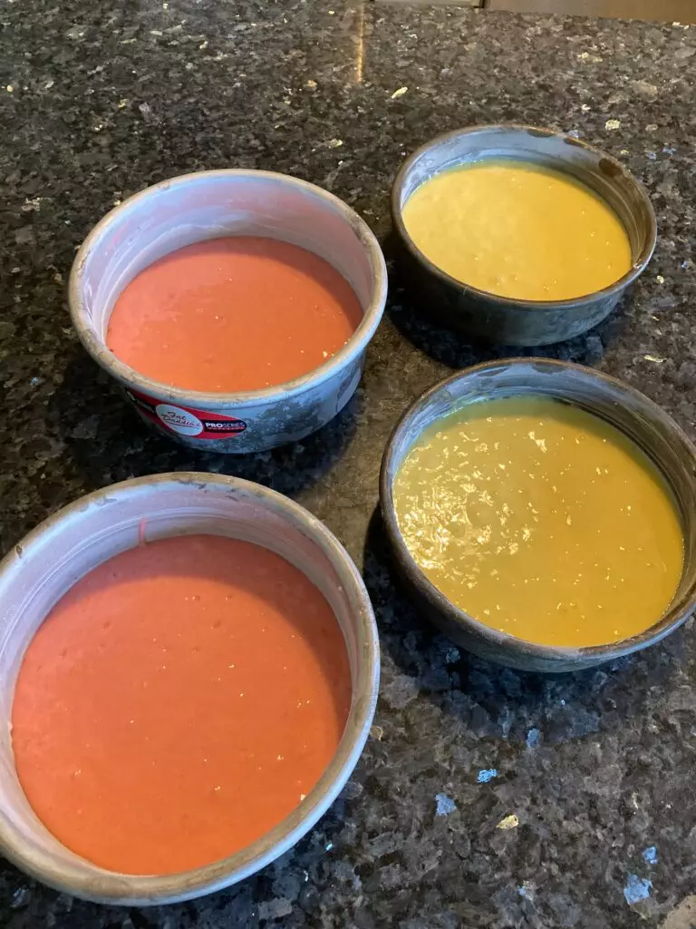 lemon and strawberry cake batter in pans