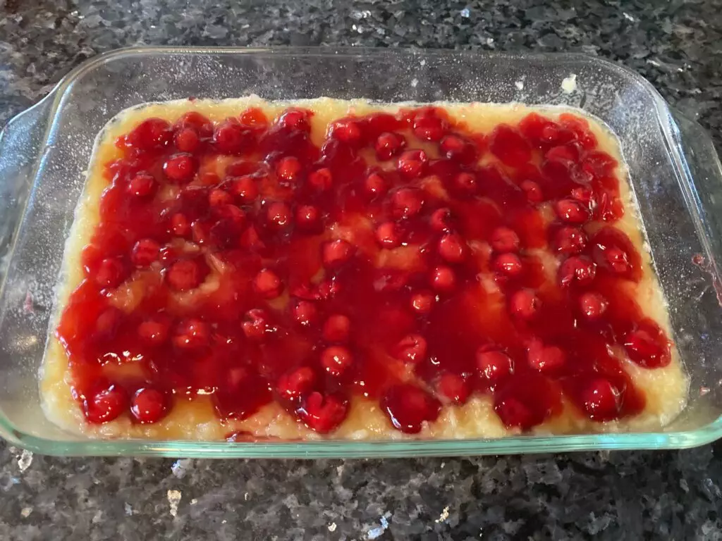 cherry pie filling on top of pineapple and brown sugar