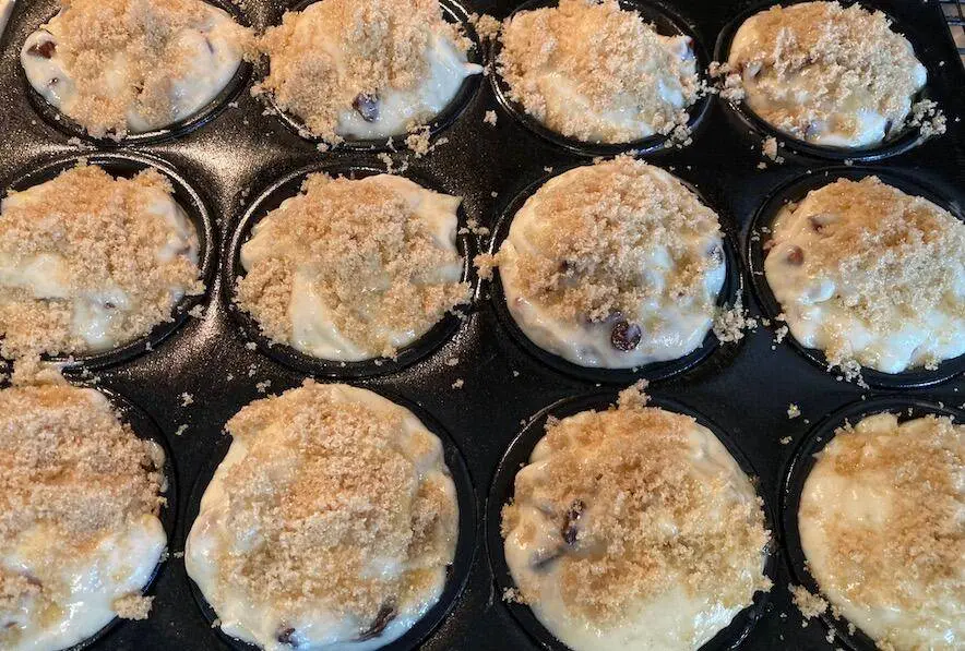 banana muffin batter in pan with topping