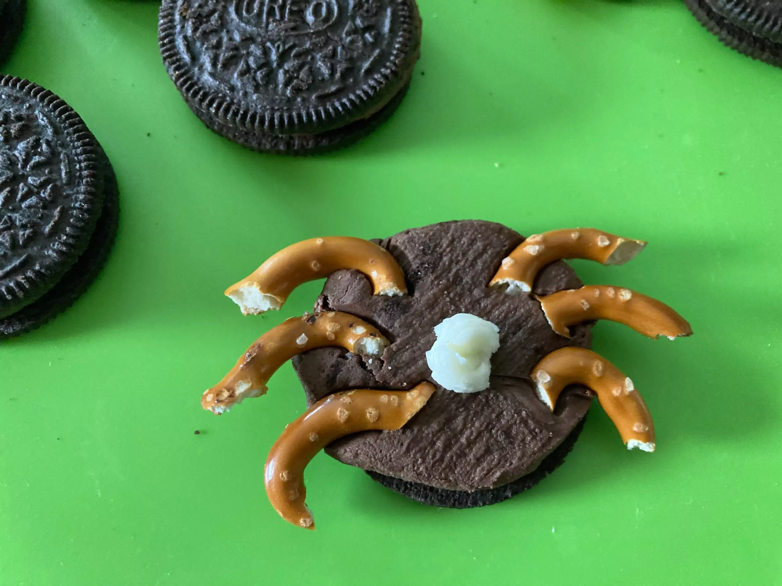 Putting Oreo Spiders legs in from Out of the Box Baking.com
