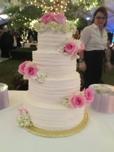 four-tiered wedding cake in white with pink flowers