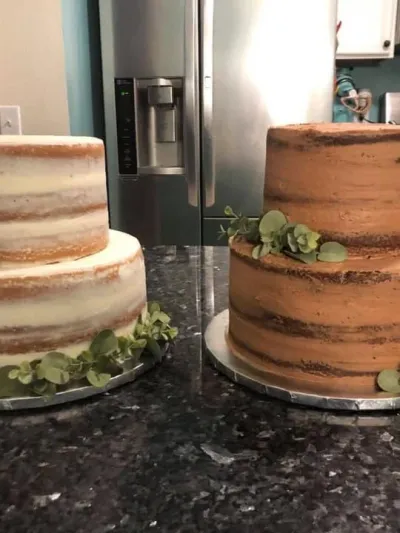 two small wedding cakes side by side, one white, one chocolate, both naked cakes