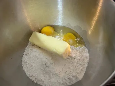 mixing bowl with powdered sugar, butter, and eggs