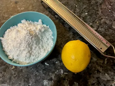 powdered sugar, lemon, and zester on countertop