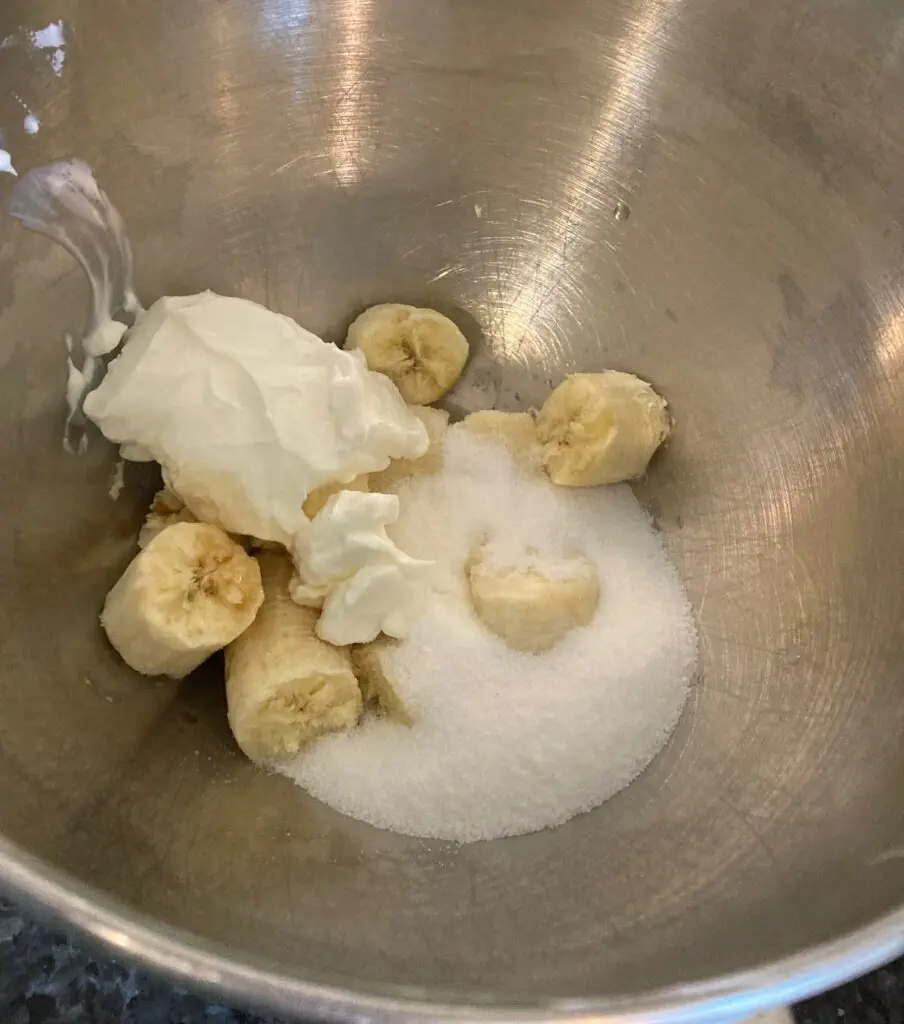 bananas, sour cream, monk fruit, vanilla in mixing bowl