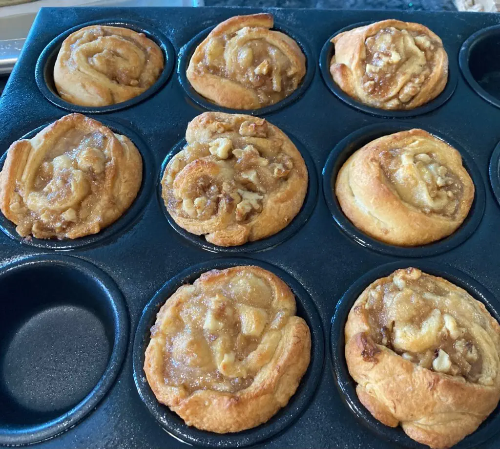 bananas foster cinnamon rolls in muffin tin