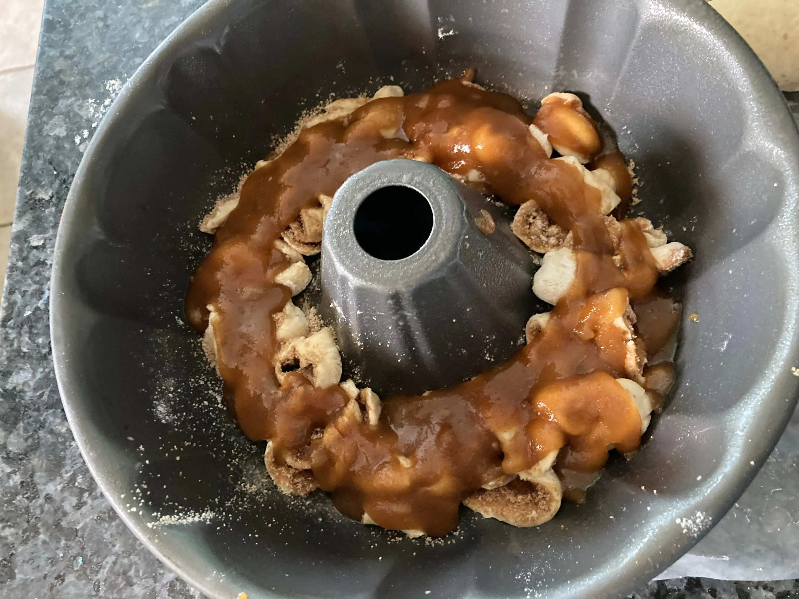 brown sugar sauce on cinnamon roll layer from Out of the Box Baking.com